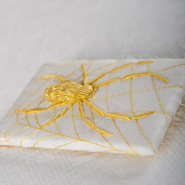 Brooch embroidered with spider thread and gold thread
