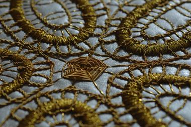 Goldwork embroidery on leather sofa