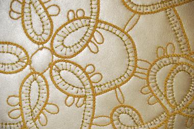 Goldwork embroidery on leather sofa